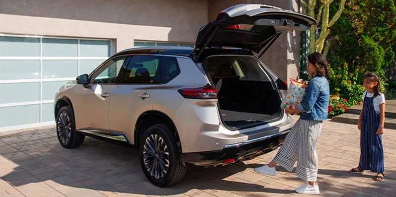 A silver 2025 Nissan Rogue parked in the driveway.