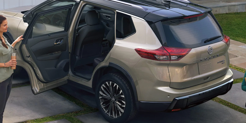 2026 Nissan Rogue with rear door open showcasing spacious interior and passenger access